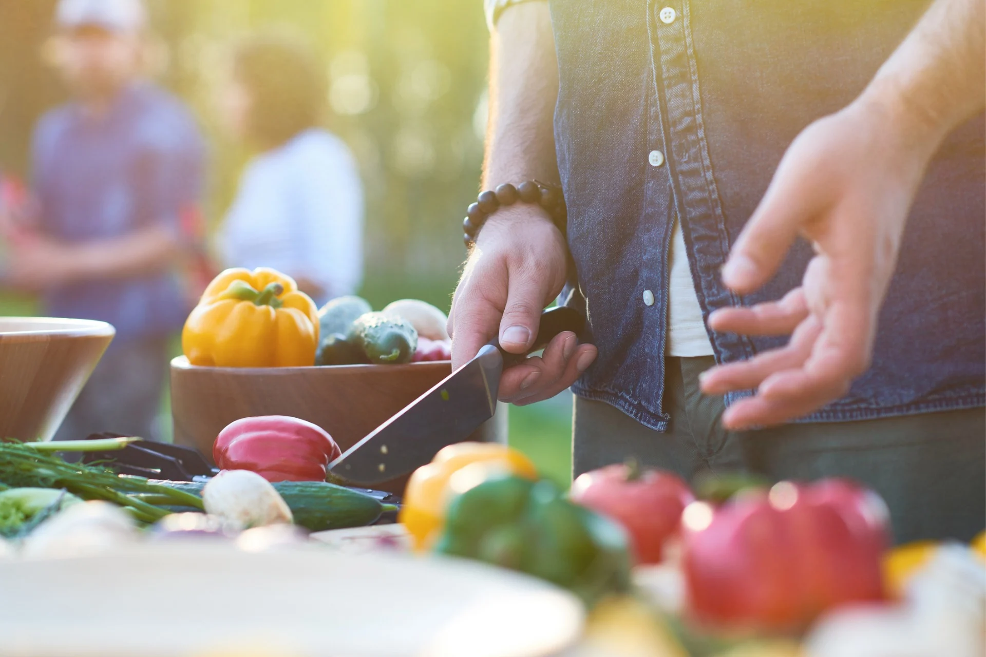 man preparing vegetables at bbq